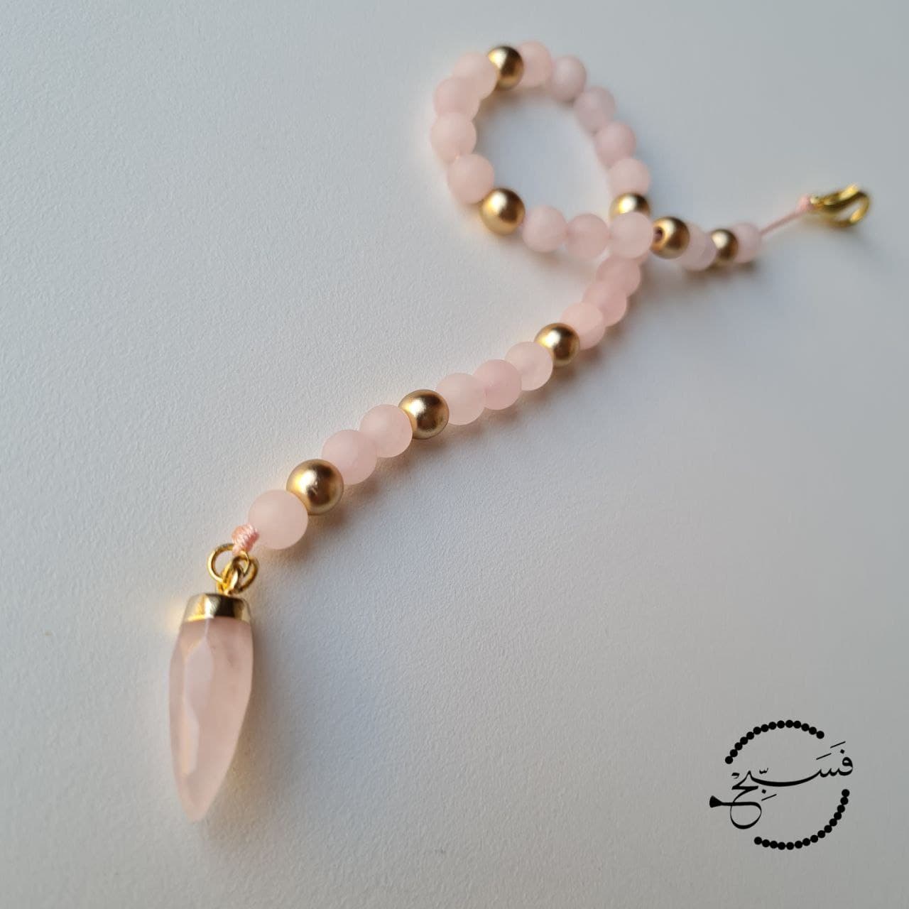 Rose quartz bag charm for dhikr on the go!   33 bead tasbih that can be attached to your bag.   Packaged in a luxurious pouch and a gift box.