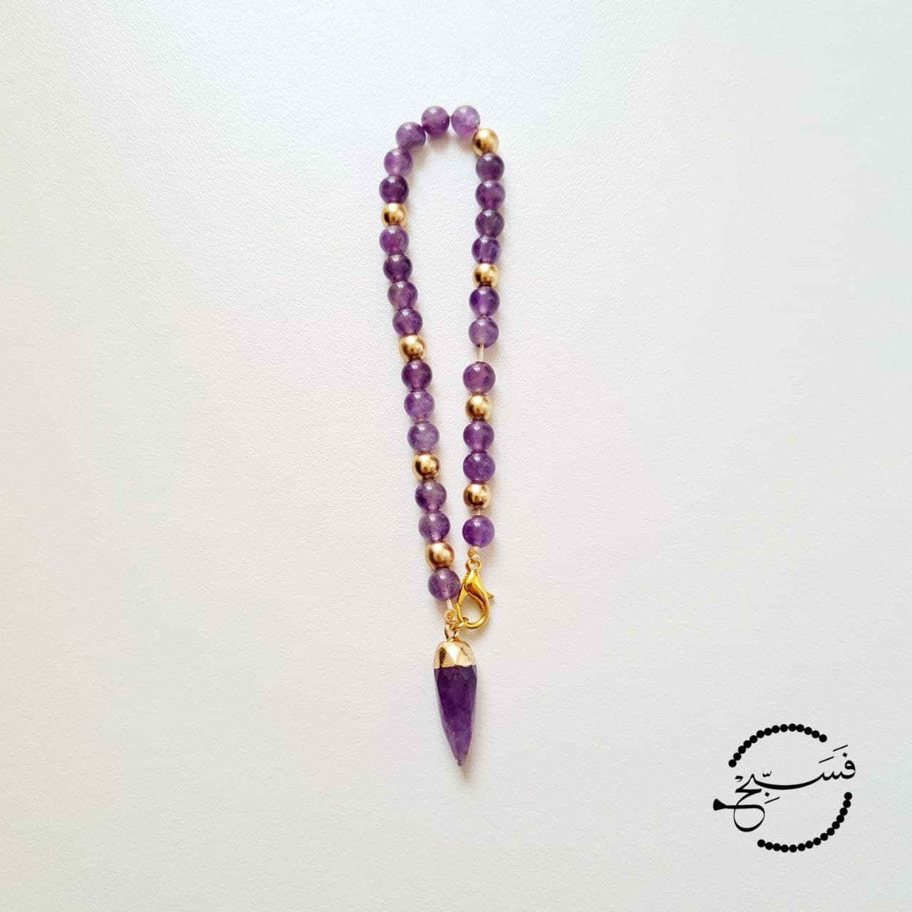 Amethyst & matte gold beads paired with an amethyst pendant.   33 bead tasbih that can be attached to your bag.   Packaged in a luxurious pouch and a gift box.